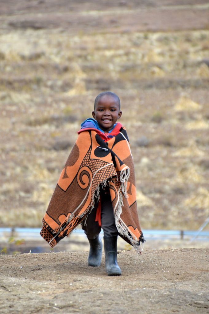 Basotho child wearing a traditional blanket and gumboots